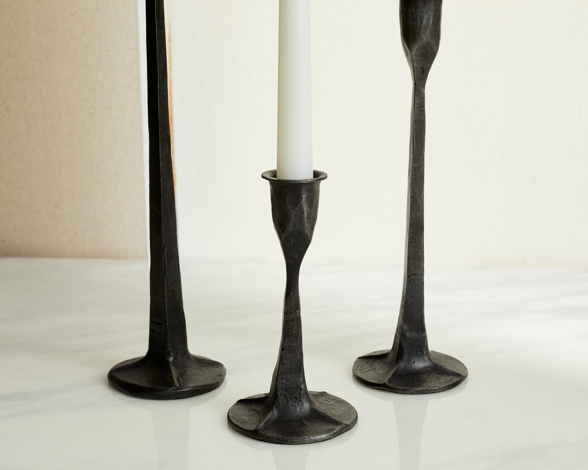 Close-up of Bloomsbury Iron Black candle holder set of 3 styled on dining table