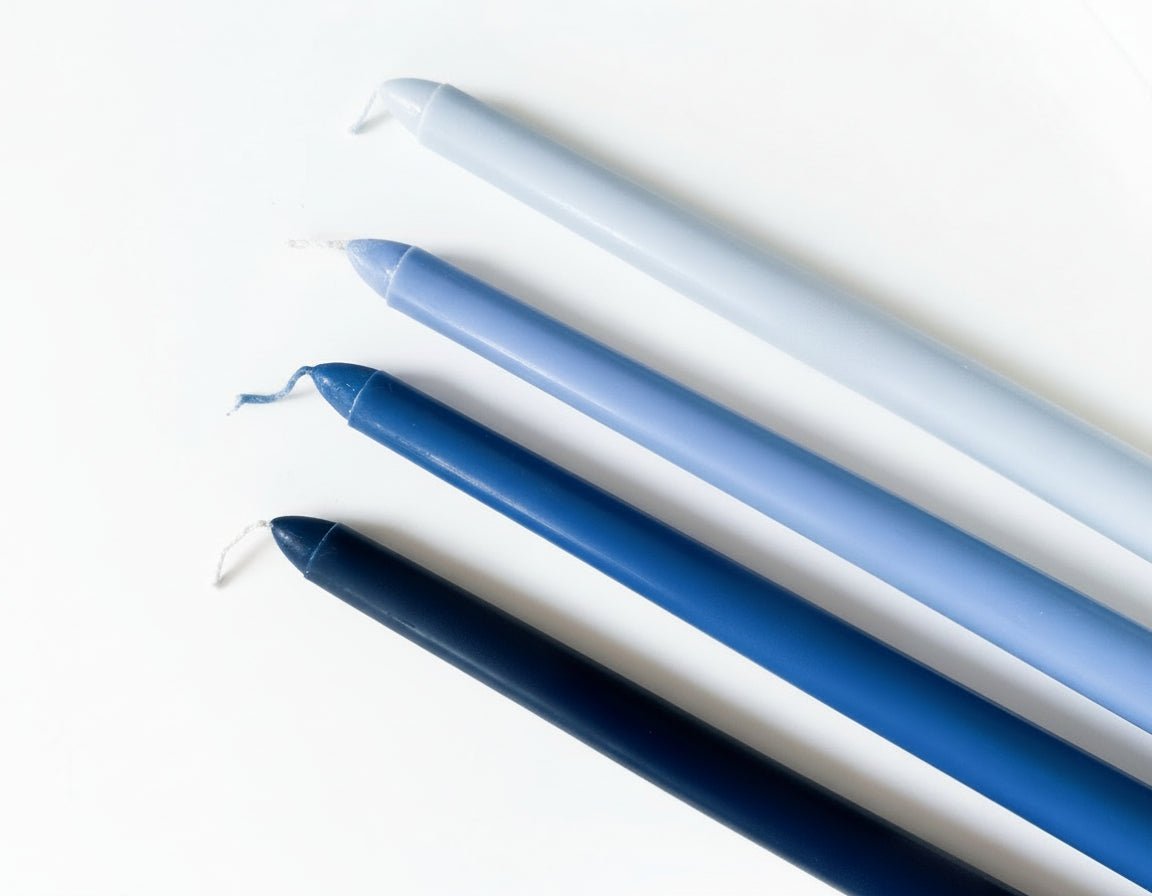 Blue taper candles floral scented box of four displayed on blank background
