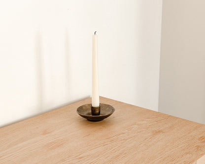 Brambourne candle holder rustic iron taper holder styled on edge of wooden table
