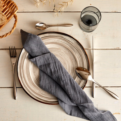 Branston silver stainless steel cutlery set styled in a simple place setting with natural linen and ceramic plate—evokes timeless hosting and countryside charm.