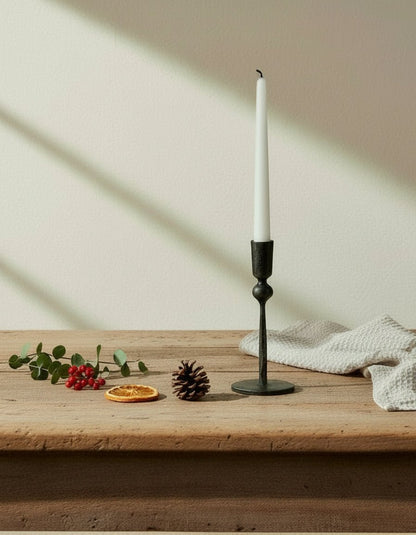 Coalbrook iron black candle holder on farmhouse table with tea towel and festive sprig