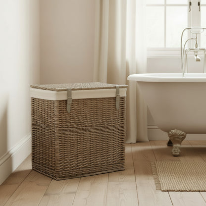 Elmsmere wicker laundry basket with cotton lining in bathroom with rolltop bath, wooden floor and natural rug
