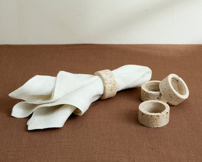 Travertine napkin rings styled on a countryside-inspired tabletop with soft linens and natural textures, evoking timeless charm and soulful hosting.