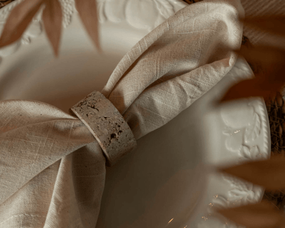 Travertine napkin rings with soft veining and polished finish, styled with natural linens for elegant table settings and timeless countryside charm.