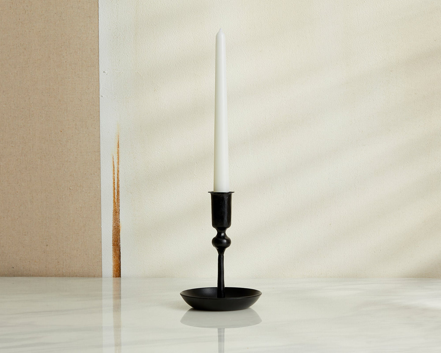 Forge Ember iron candle holder matte black forge inspired accent styled on marble table top
