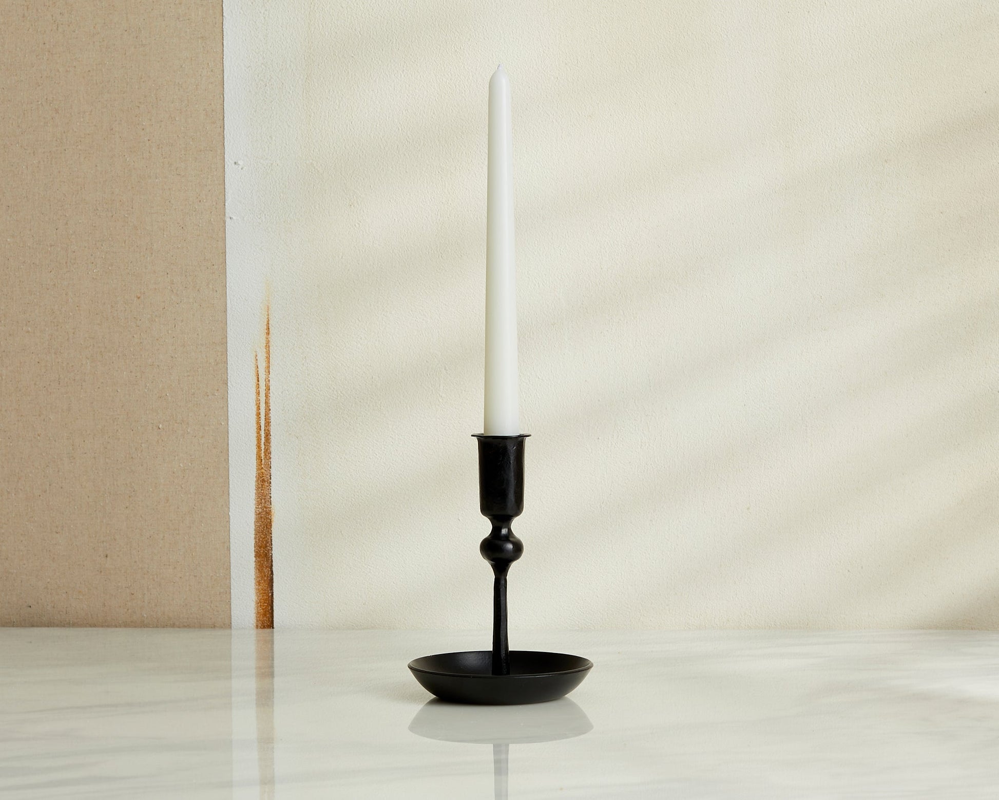 Forge Ember iron candle holder matte black forge inspired accent styled on marble table top
