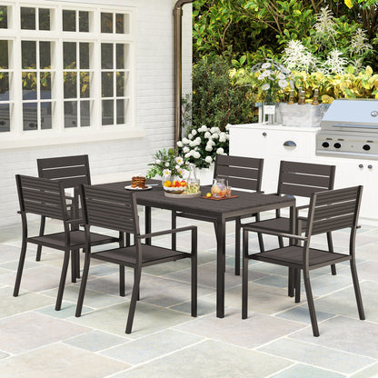 The Hardwick Gathering 7-piece garden dining set with dark brown HDPE slatted table and six stackable steel-frame chairs, styled on a stone patio for timeless outdoor hosting