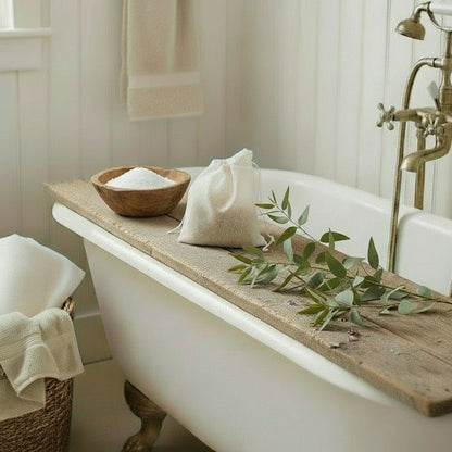 Bathroom with a white rolltop bathtub, wooden bathboard, and decorative elements.