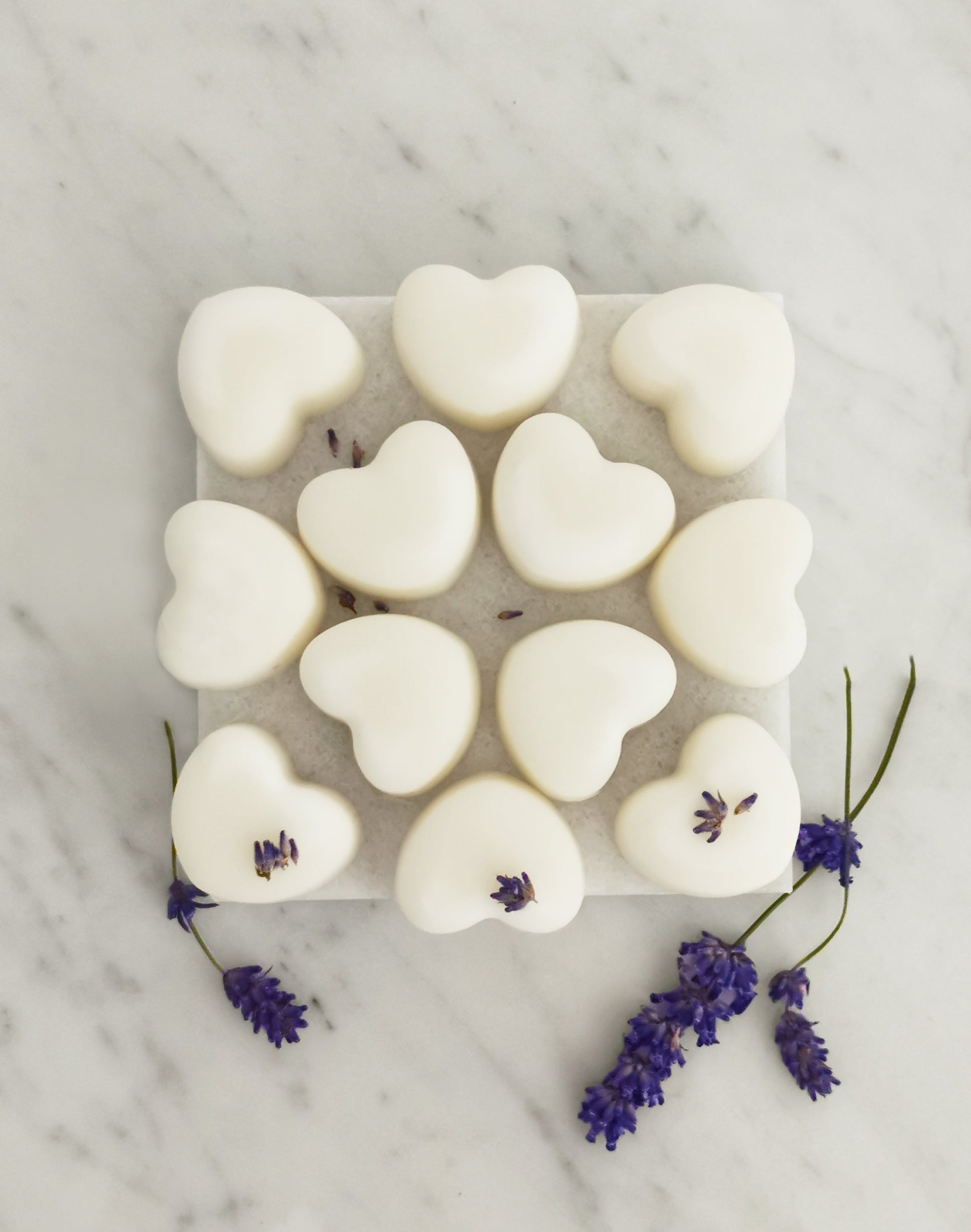 Lavender and ylang ylang aromatherapy wax melts with natural essential oils displayed on rustic tile
