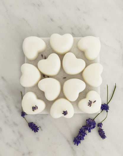 Lavender and ylang ylang aromatherapy wax melts with natural essential oils displayed on rustic tile
