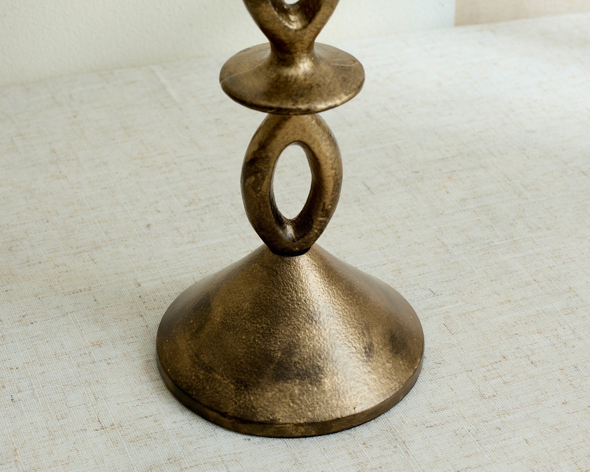 Close view of Ludlow gold candle holder base, irregular sculptural shape with modern elegance