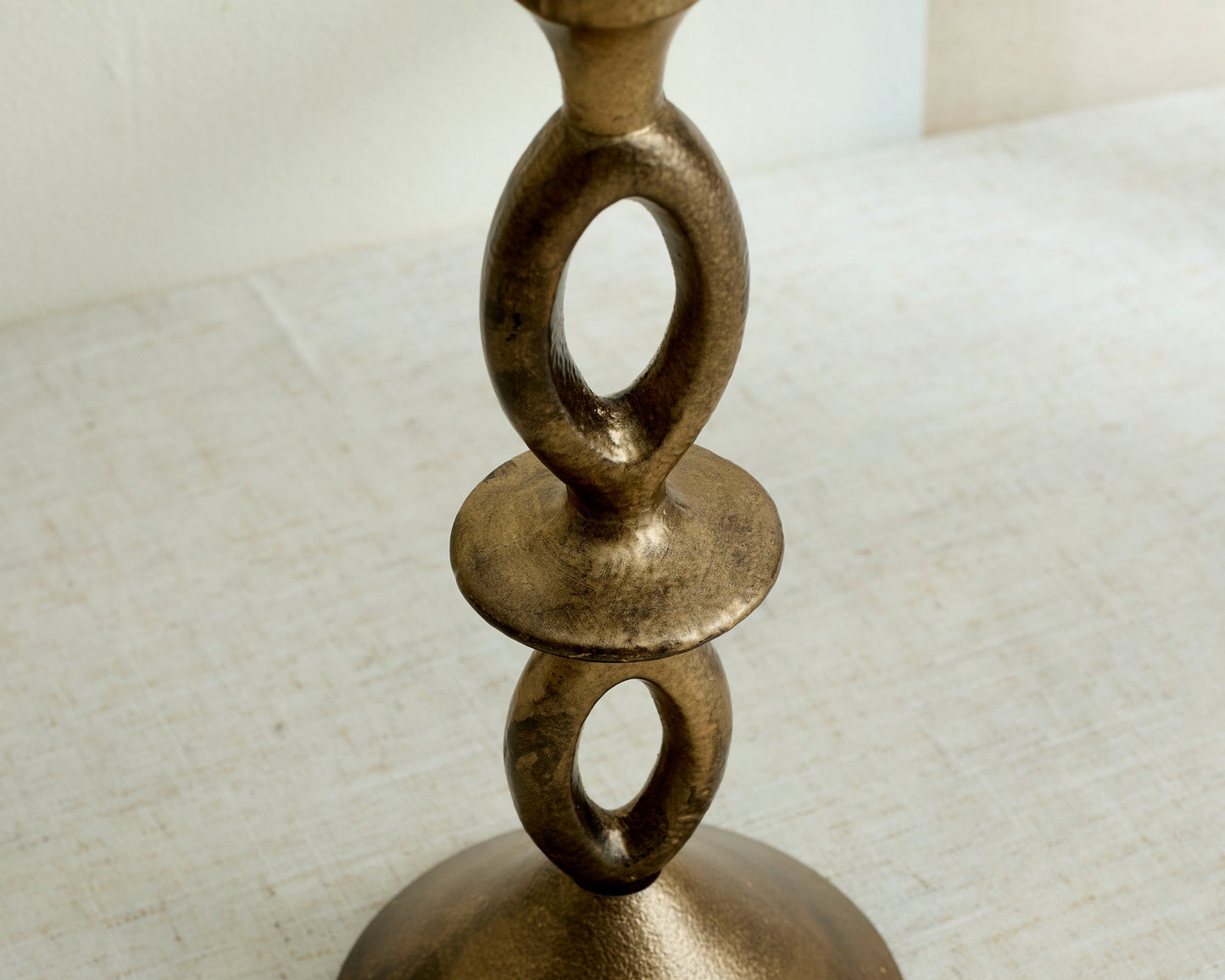 Detail shot of Ludlow gold candle holder base, organic irregular form in iron metal finish