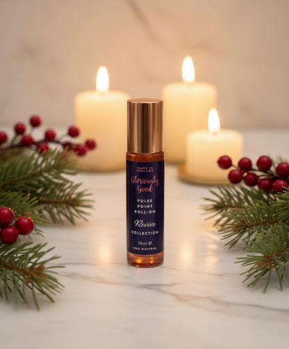 Side view of peppermint eucalyptus pine roll-on Christmas aromatherapy gift with festive sprigs
