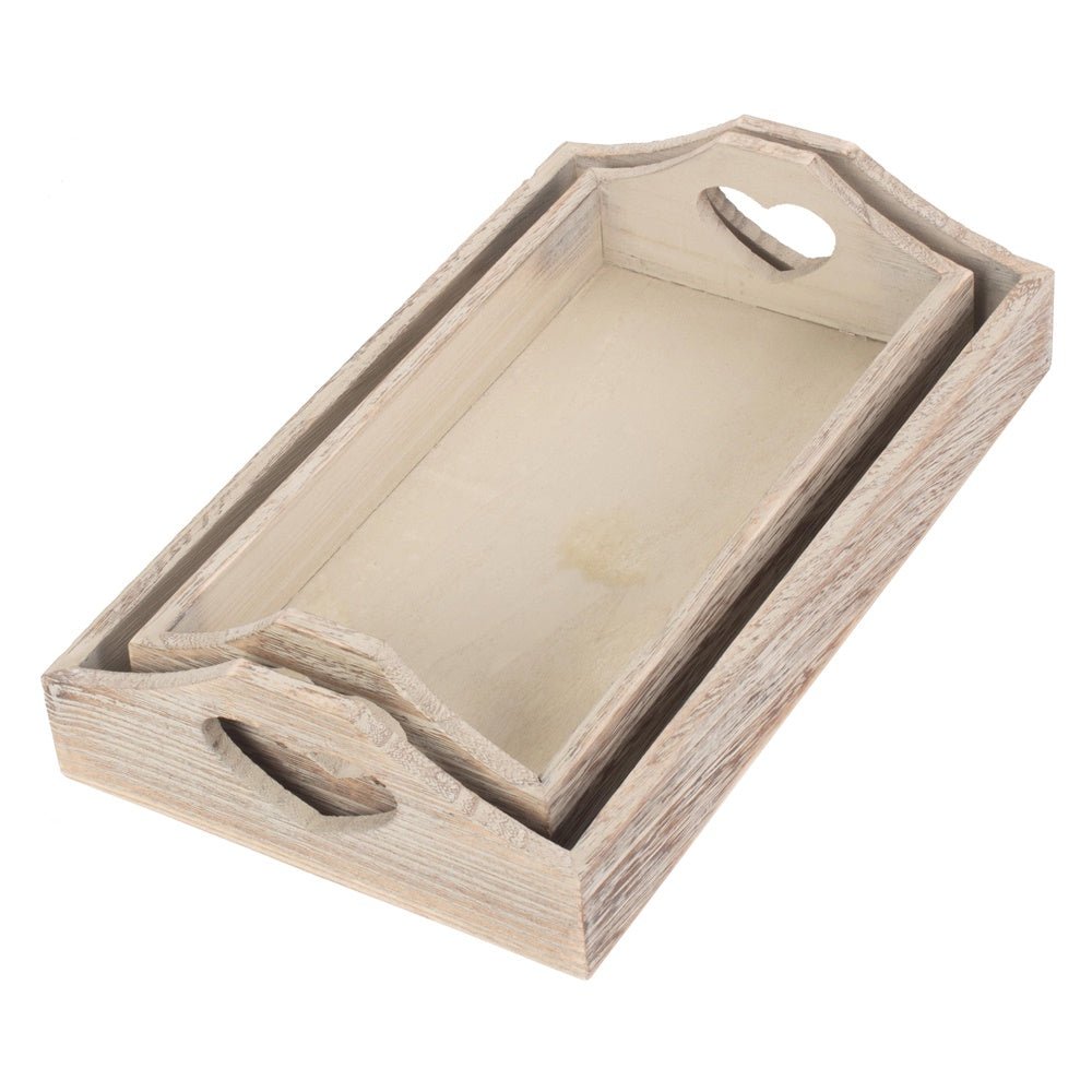 Two shallow heart wooden trays nested together on white background, rustic storage styling in soft-grain wood