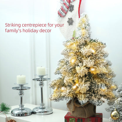 Set of two 1.5ft snow-flocked tabletop Christmas trees with warm white LED lights styled as a festive centrepiece. Linen-wrapped bases with rustic seasonal charm.