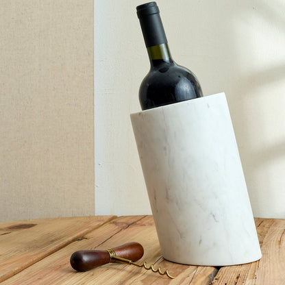 The Thistle Cellar Key corkscrew placed beside a rustic wine bottle holder—acacia and steel opener styled for heritage bar rituals and soulful hosting