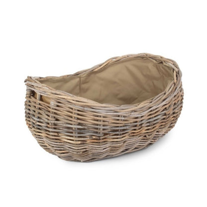 Large boat-shaped rattan log basket with Cordura lining — handwoven fireside storage inspired by coastal cottages and timeless countryside interiors