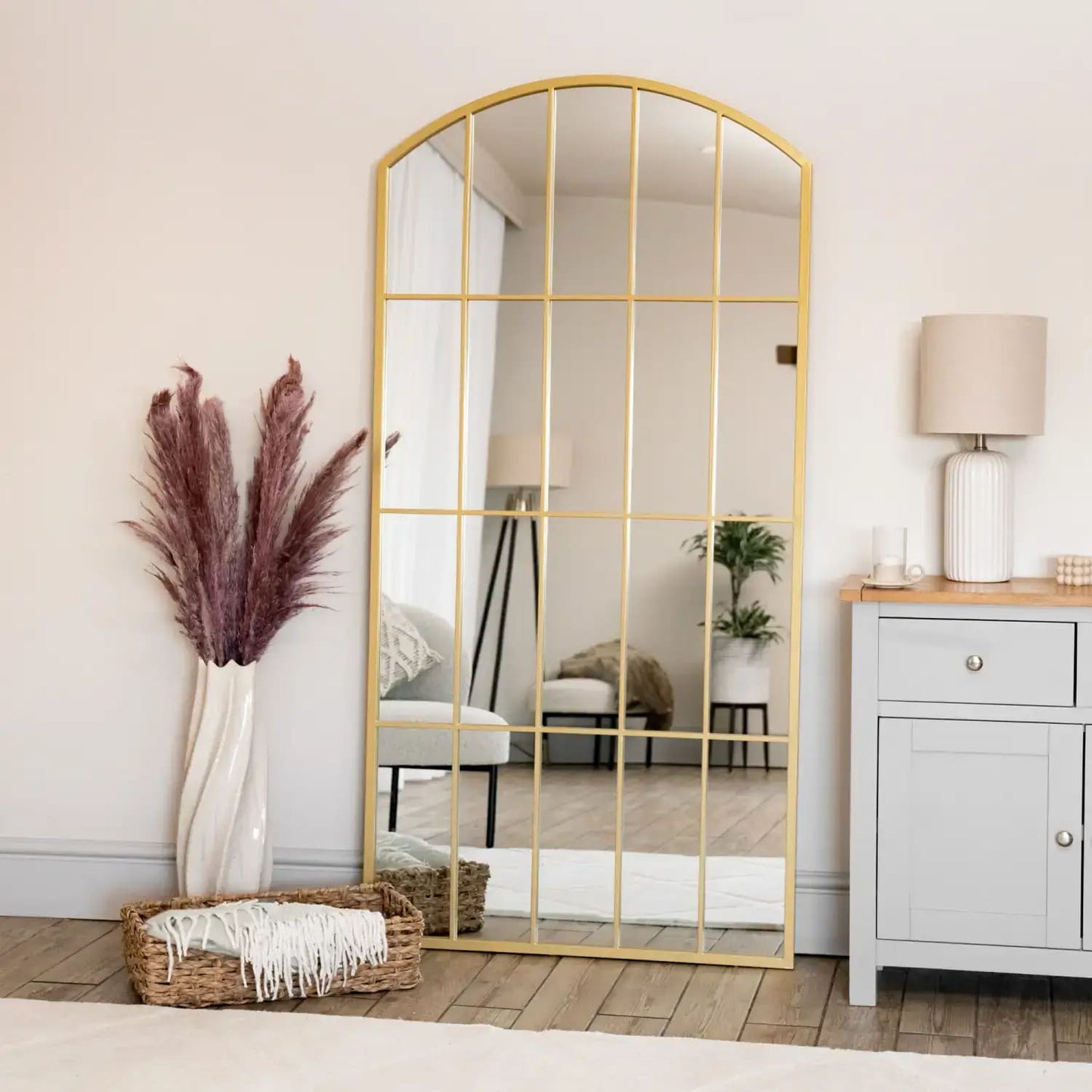 Full-length arched gold lattice mirror with windowpane design — styled for hallway light and countryside elegance