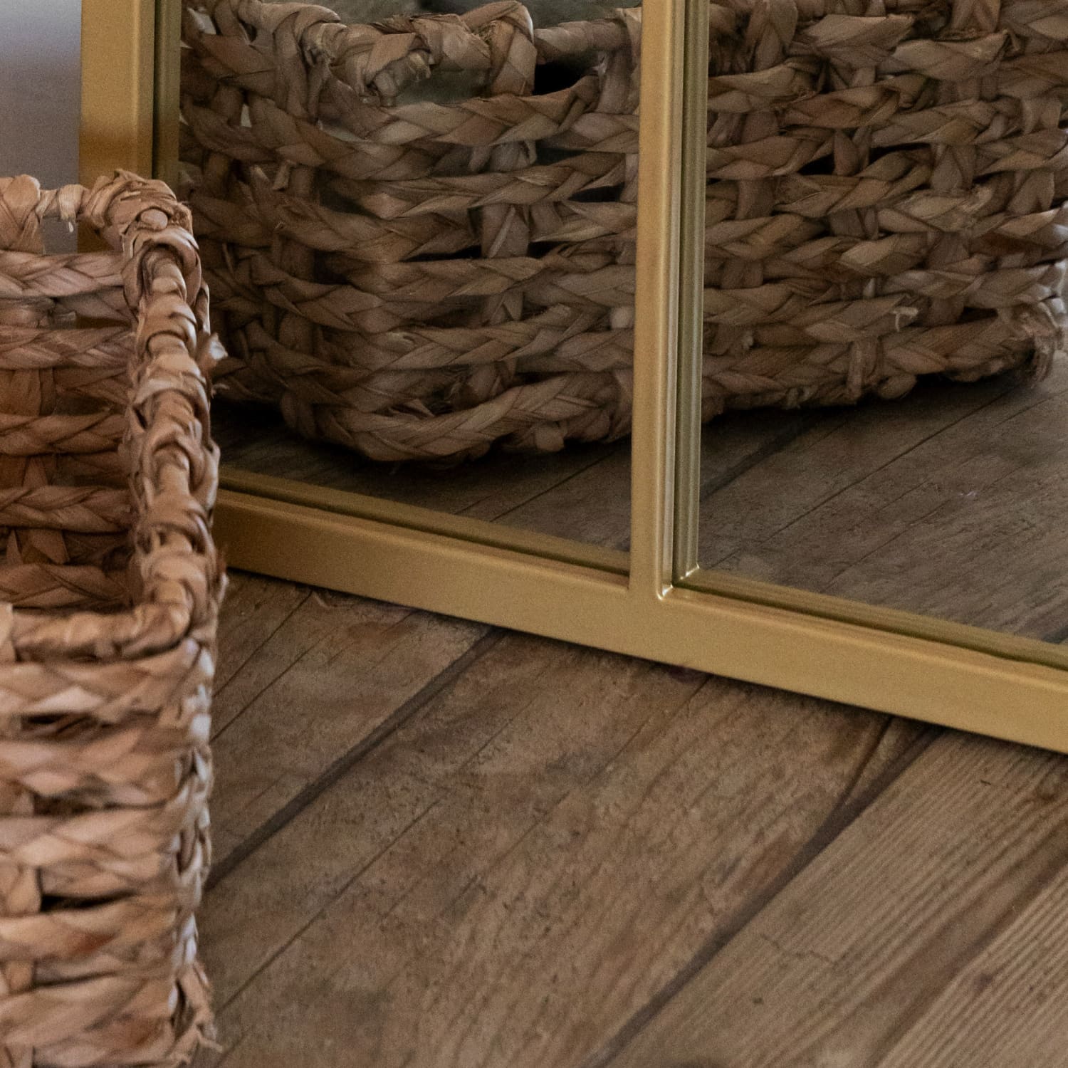 Bottom detail of gold arched lattice mirror — antique-style metal frame with soft patina and countryside-inspired charm