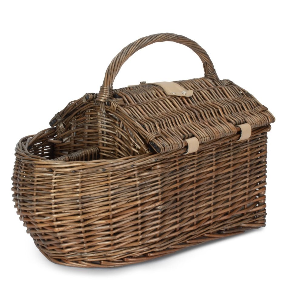 Boat-shaped wicker picnic basket with fitted interior — styled outdoors for countryside picnics, dockside lunches, and timeless alfresco gatherings