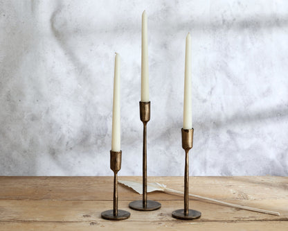Weldon iron candle holder set rustic taper holders all three sizes styled on wooden table top
