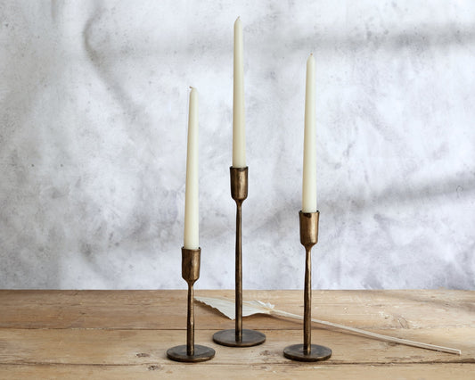 Weldon iron candle holder set rustic taper holders all three sizes styled on wooden table top
