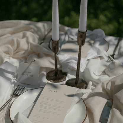 Weldon Iron Candle Holder Set – antique brass finish, styled on formal wedding table with elegant organza, place name, and menu for timeless celebration
