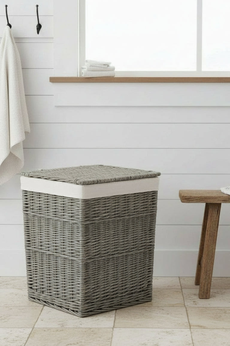 Antique wash wicker laundry basket with white cotton lining, square design in bathroom setting

