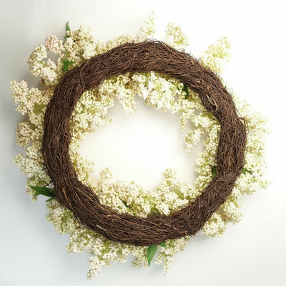 Back view of Winterberry wreath showing woven base and hanging loop, lightweight structure for easy styling and festive display