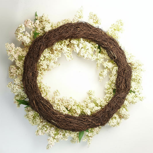 Back view of Winterberry wreath showing woven base and hanging loop, lightweight structure for easy styling and festive display