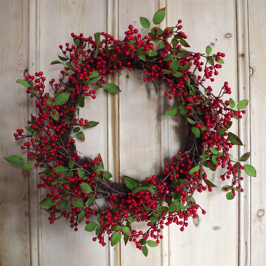 The Winthrop redberry wreath on rustic door, 24 inch round festive styling with heritage foliage and snow-kissed seasonal tones