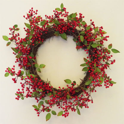 The Winthrop redberry wreath styled on interior wall, 24 inch round festive decor with rustic foliage and heritage-inspired seasonal charm