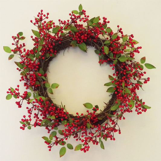 The Winthrop redberry wreath styled on interior wall, 24 inch round festive decor with rustic foliage and heritage-inspired seasonal charm