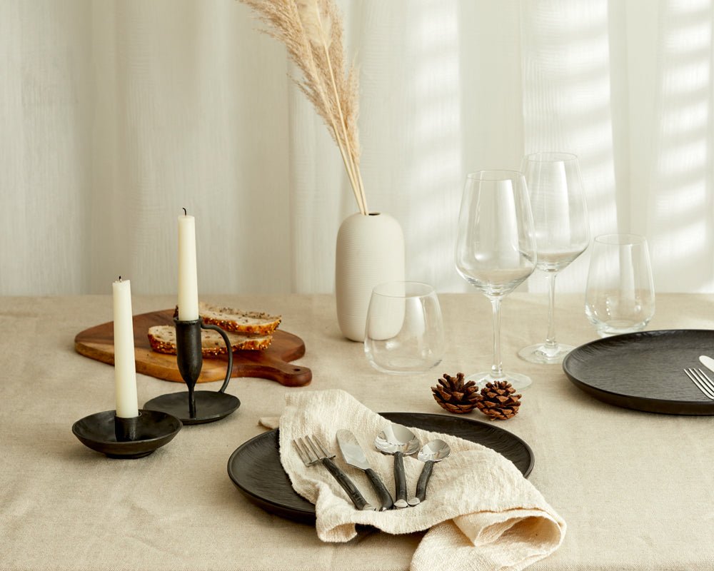 Wroughtmoor iron candle holder antique black compact accent placed in tablescape with natural textures
