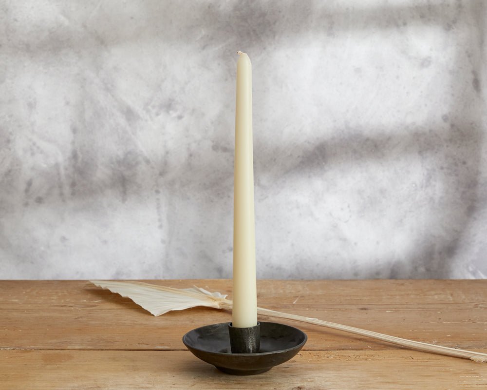 Wroughtmoor iron candle holder antique black compact accent styled on wooden table top
